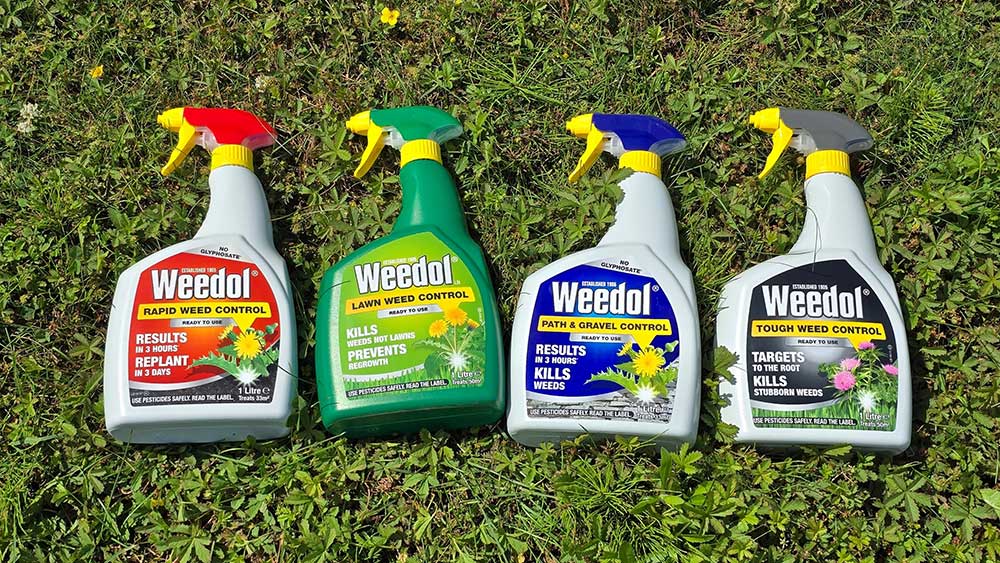 4 bottles of Weedol Weed Killer laying on a green lawn